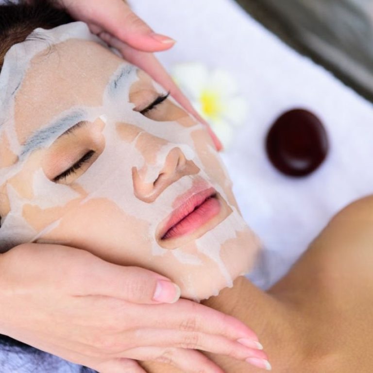 Portrait of beautiful asian people has masking with close up view and close up eyes and having hand massage in spa salon. Beauty, healthy, spa and relaxation concept.